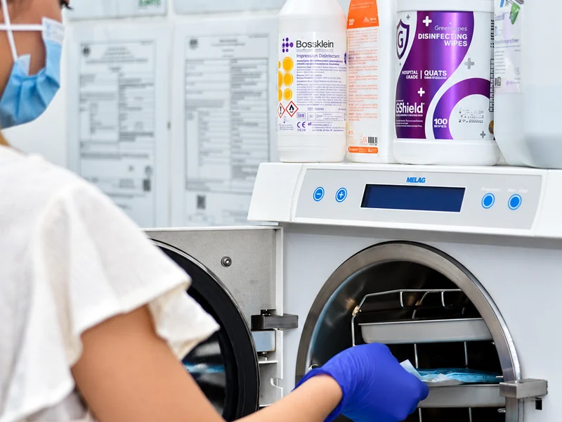 Instruments being loaded into the clinic's MELAG vacuum autoclave