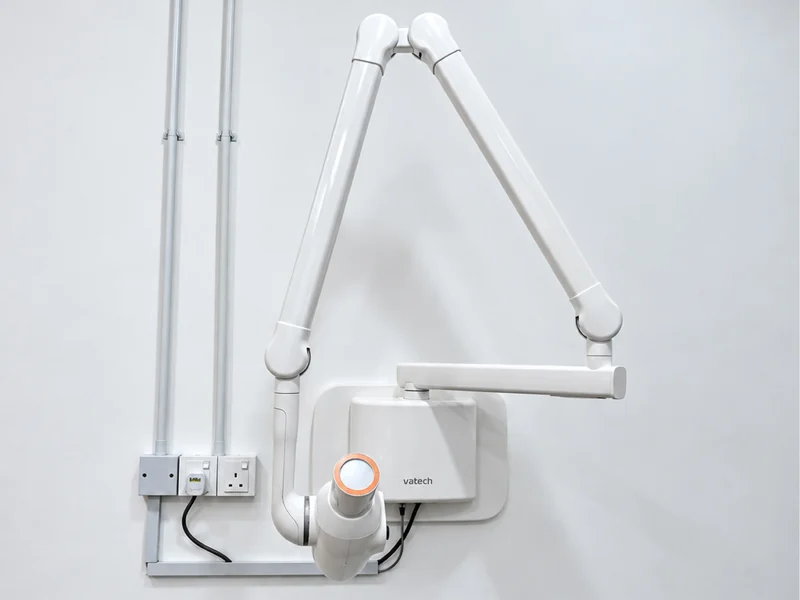 Wall-mounted Vatech intraoral X-ray arm in a treatment room