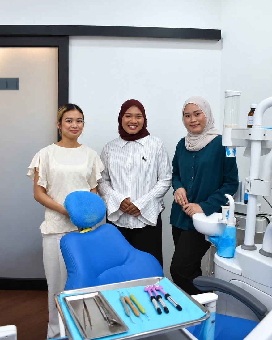 The dental surgery assistants beside the treatment chair